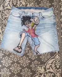 a pair of denim shorts with a cartoon character on them