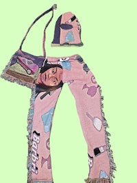 a pair of pants and a purse with an image of a woman